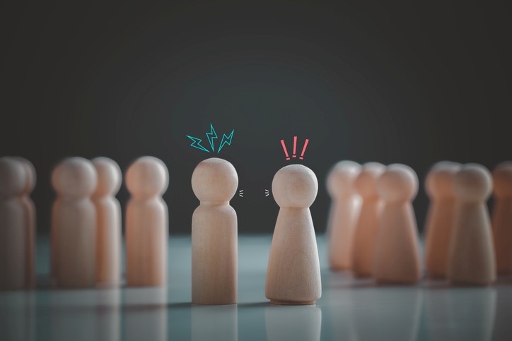 A group of wooden figures facing each other
AI-generated content may be incorrect.